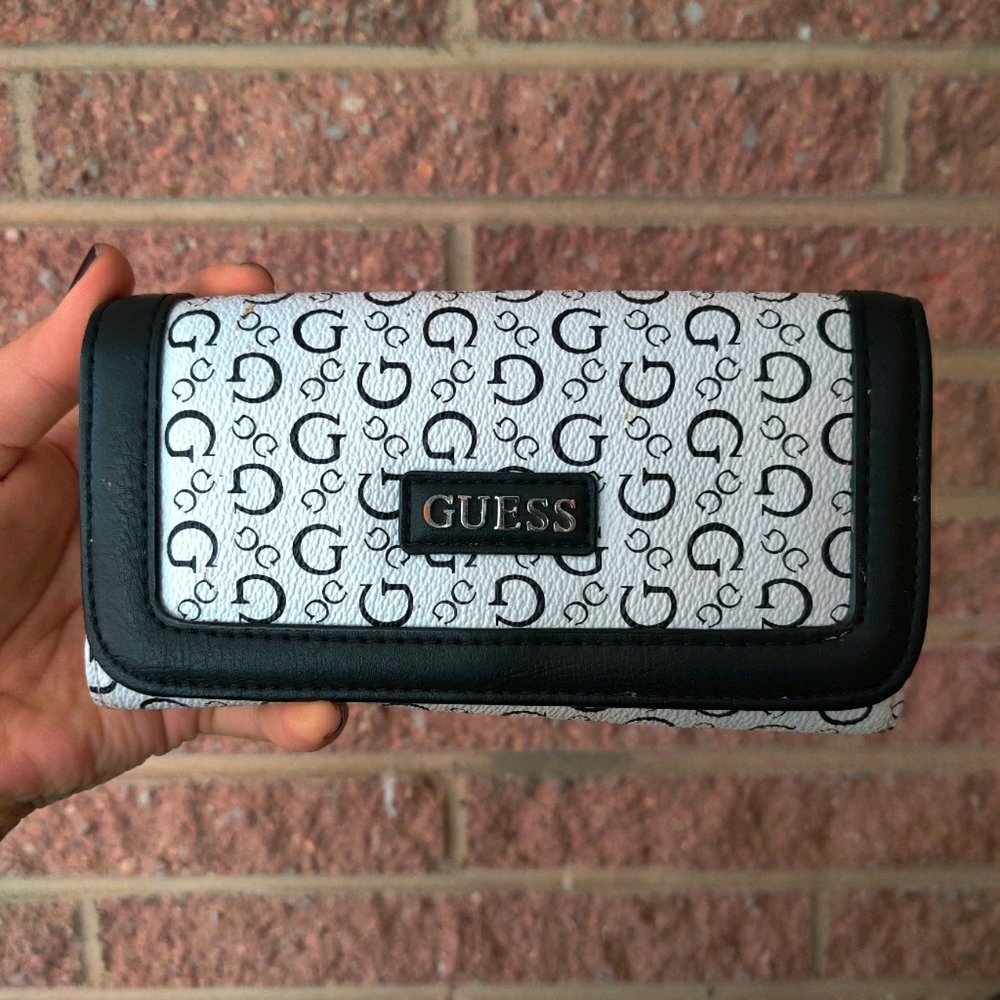 Guess tri-fold wallet with snap closure.